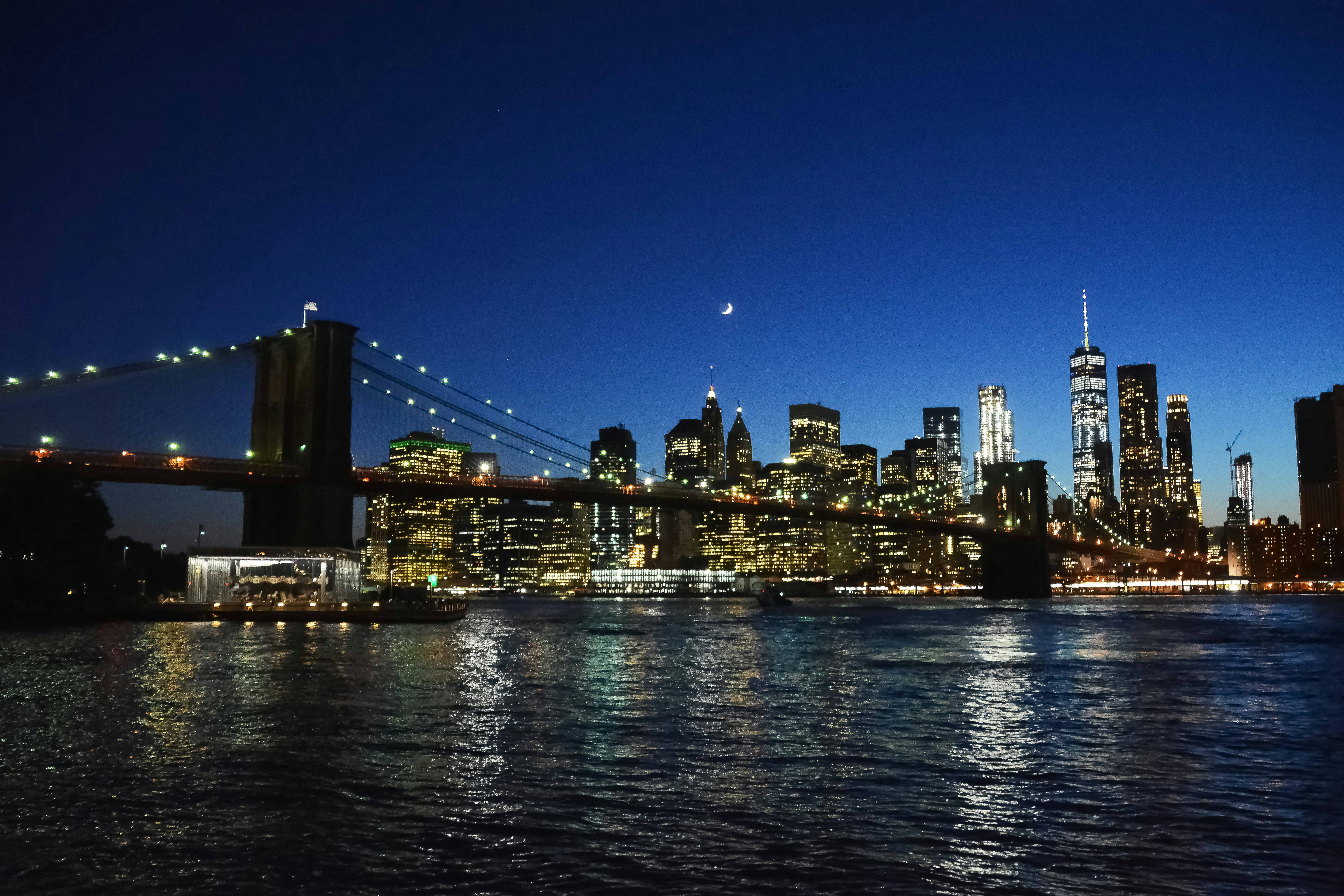 lighted bridge over water during night time